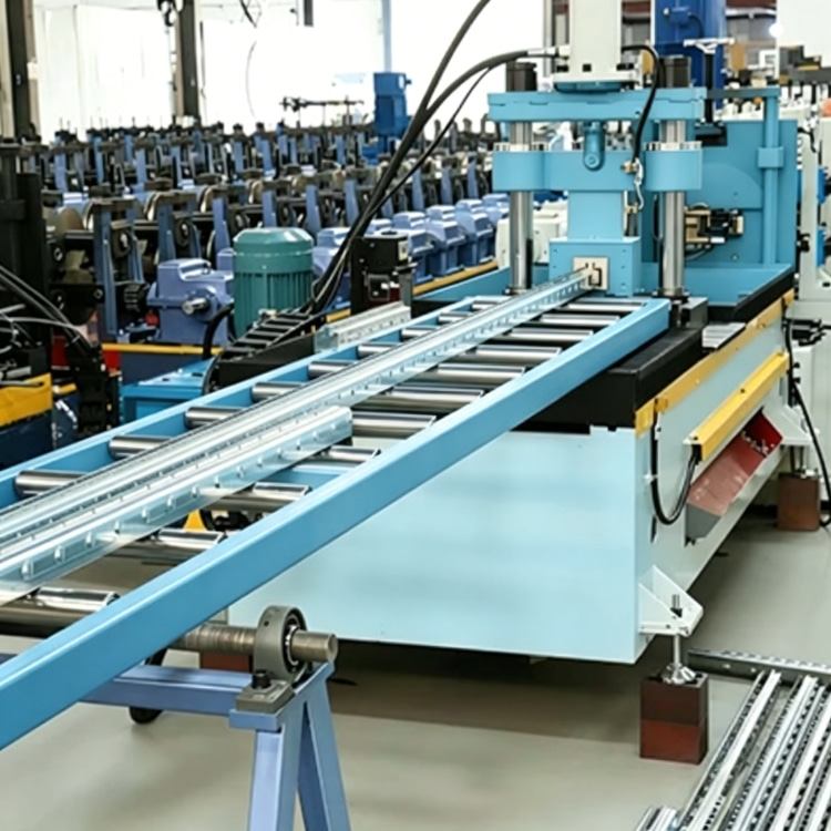 Shelf Rack Roll Forming Machine, a high-precision industrial equipment specialized in mass production of shelf rack uprights. The machine features a robust steel frame, integrated PLC control system with touchscreen interface, and multi-station forming rolls, showing its compact and professional structure. It is widely used in manufacturing high-quality structural components for industrial warehouses, commercial storage racks and logistics centers, with stable performance and high production efficiency.