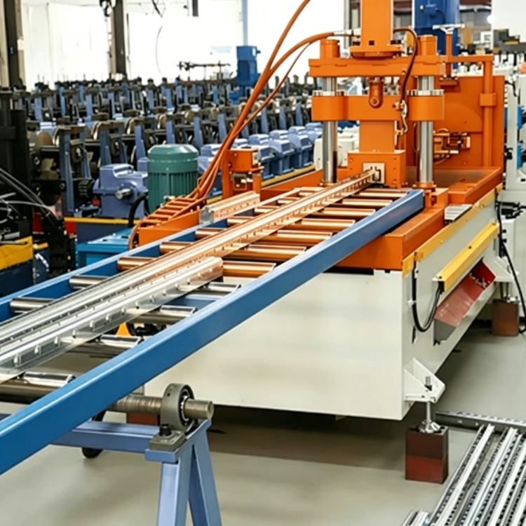 Shelf Rack Roll Forming Machine, a high-precision industrial equipment specialized in mass production of shelf rack uprights. The machine features a robust steel frame, integrated PLC control system with touchscreen interface, and multi-station forming rolls, showing its compact and professional structure. It is widely used in manufacturing high-quality structural components for industrial warehouses, commercial storage racks and logistics centers, with stable performance and high production efficiency.
